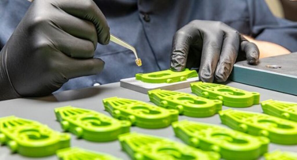 Hand assembling green 3D-printed parts