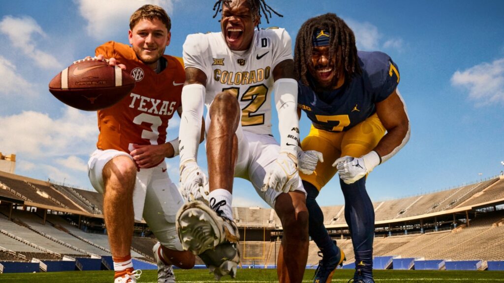 Three college football players posing on field
