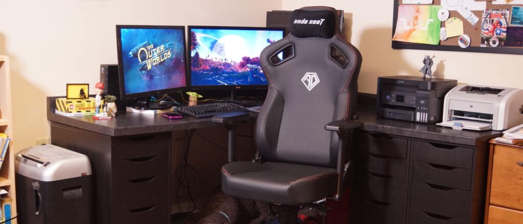 Gaming setup with chair, monitors, and accessories.